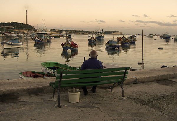 Quiet Times #12 by Jeremy Chin - Old Man on a Bench in Marsaxlokk, Malta