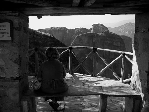 Quiet Times #44 by Jeremy Chin - Woman Enjoying the View at Monastery in Meteora, Greece