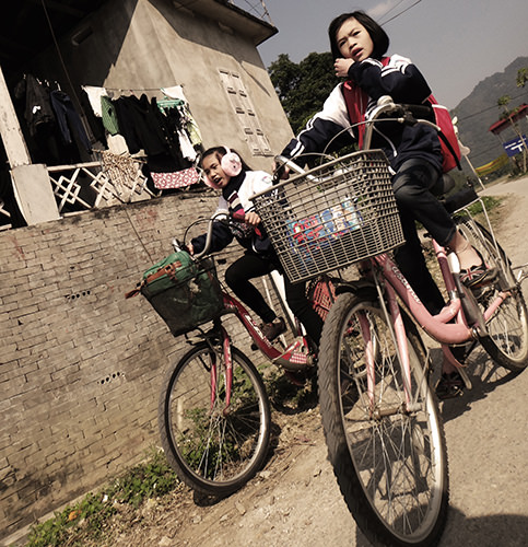 Sprouts #11 by Jeremy Chin - Young Girls on a Bicycle, Mai Chau, Vietnam.