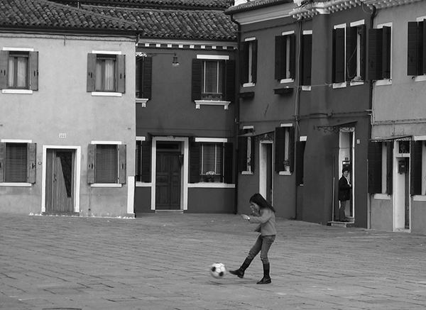 Sprouts #15 by Jeremy Chin - Girl Kicks A Football in Venice, Italy